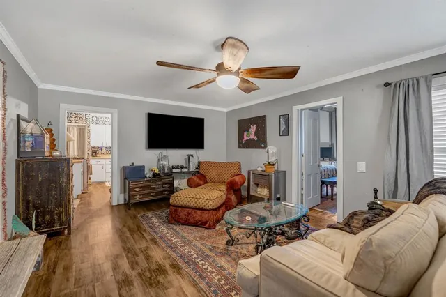 a living room with furniture ceiling fan and a rug