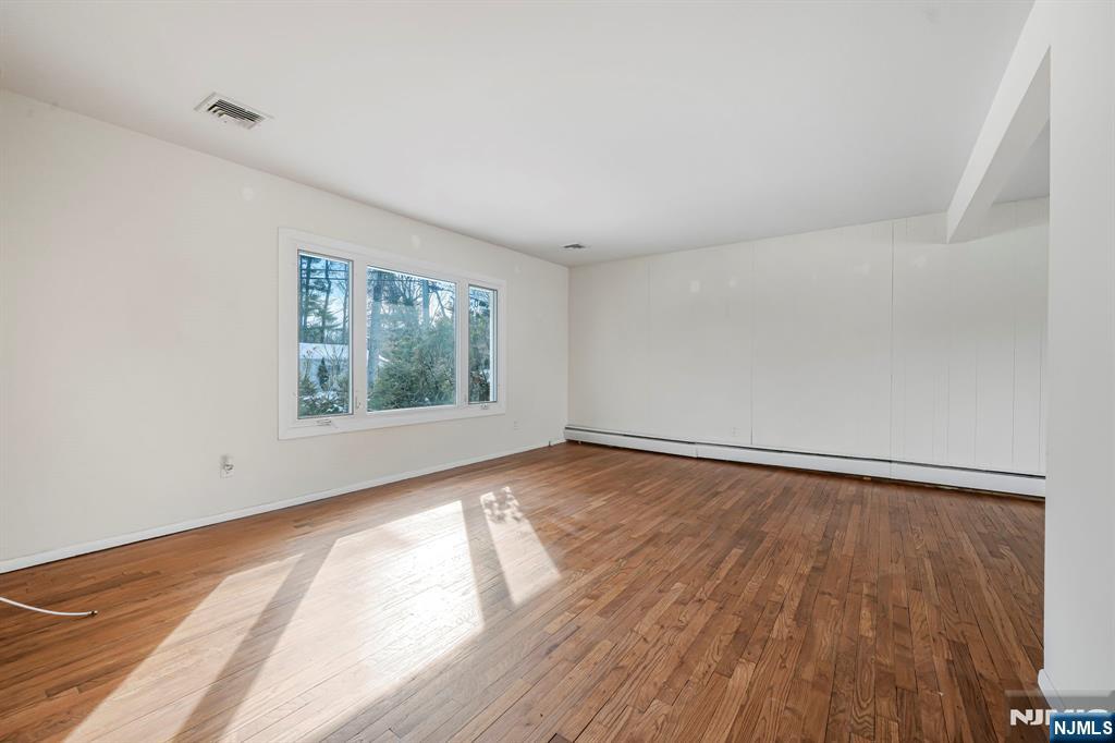 645 Wildwood Road West Northvale, NJ 07647 - Photo 15 of 35 wooden floor in an empty room with a window