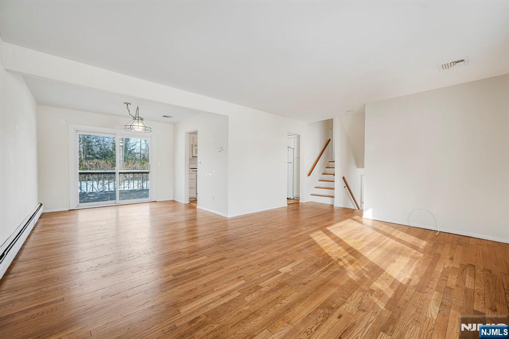 645 Wildwood Road West Northvale, NJ 07647 - Photo 16 of 35 a view of an empty room with wooden floor and a window