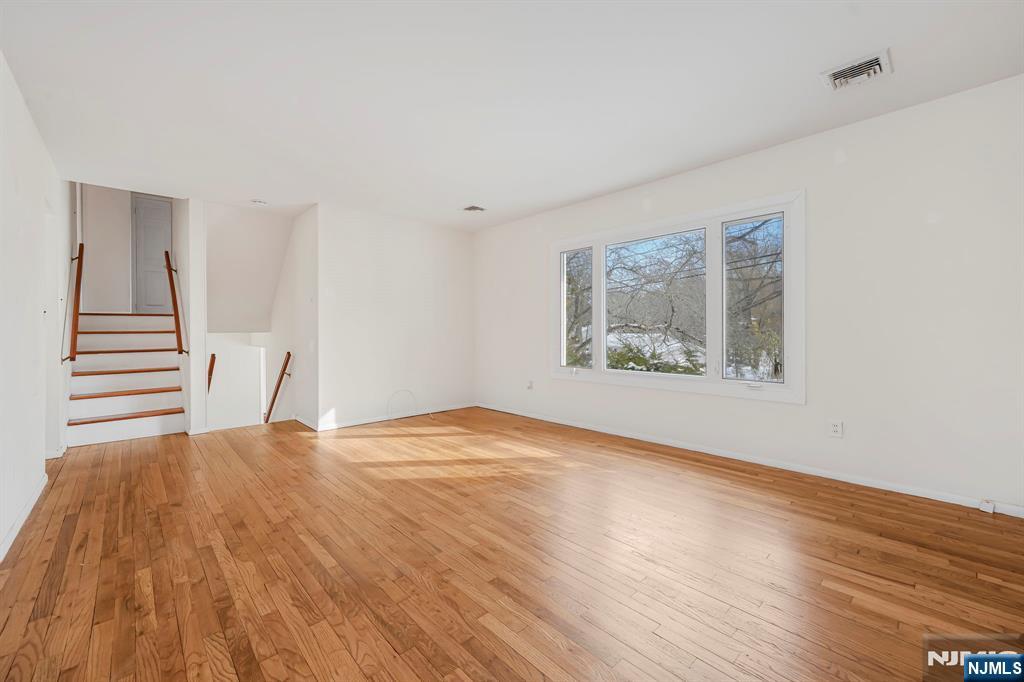 645 Wildwood Road West Northvale, NJ 07647 - Photo 17 of 35 a view of an empty room with wooden floor and a window
