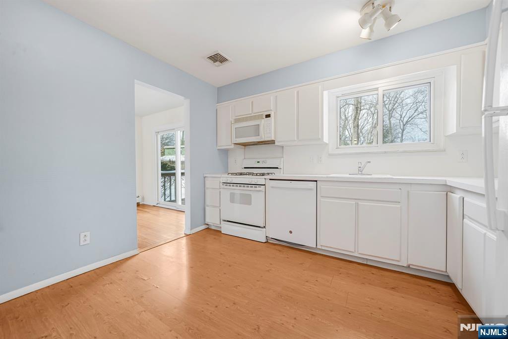645 Wildwood Road West Northvale, NJ 07647 - Photo 18 of 35 a kitchen with white cabinets and white appliances