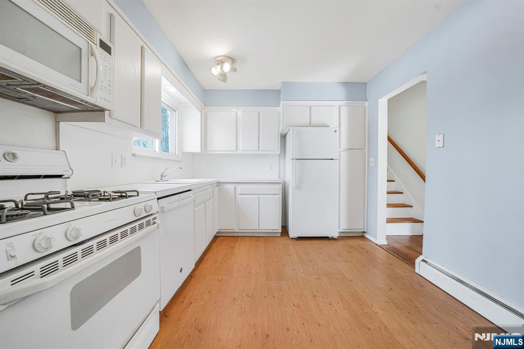 645 Wildwood Road West Northvale, NJ 07647 - Photo 19 of 35 a kitchen with a stove a sink and a refrigerator