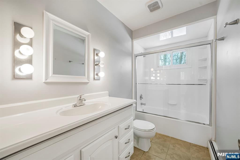 645 Wildwood Road West Northvale, NJ 07647 - Photo 20 of 35 a bathroom with a sink a toilet and shower