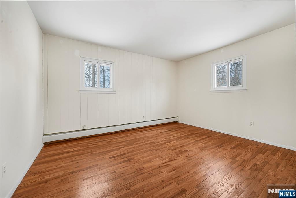 645 Wildwood Road West Northvale, NJ 07647 - Photo 21 of 35 a view of an empty room with wooden floor and a window