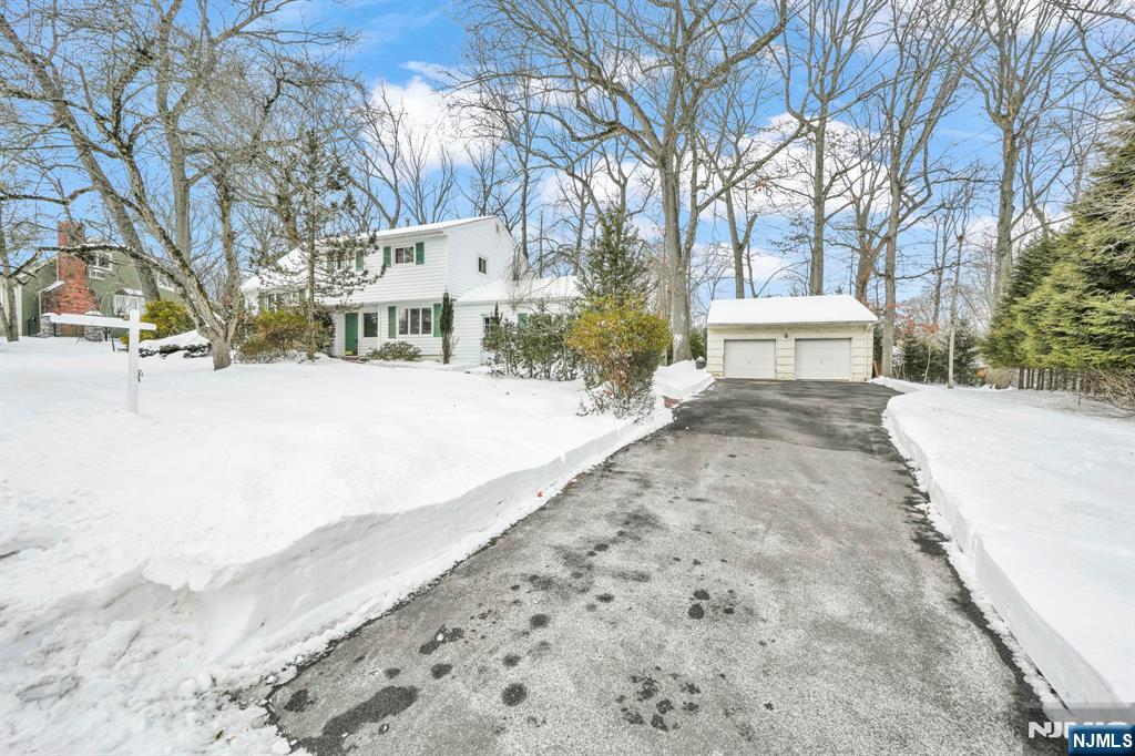645 Wildwood Road West Northvale, NJ 07647 - Photo 3 of 35 a view of white house with a yard covered in snow
