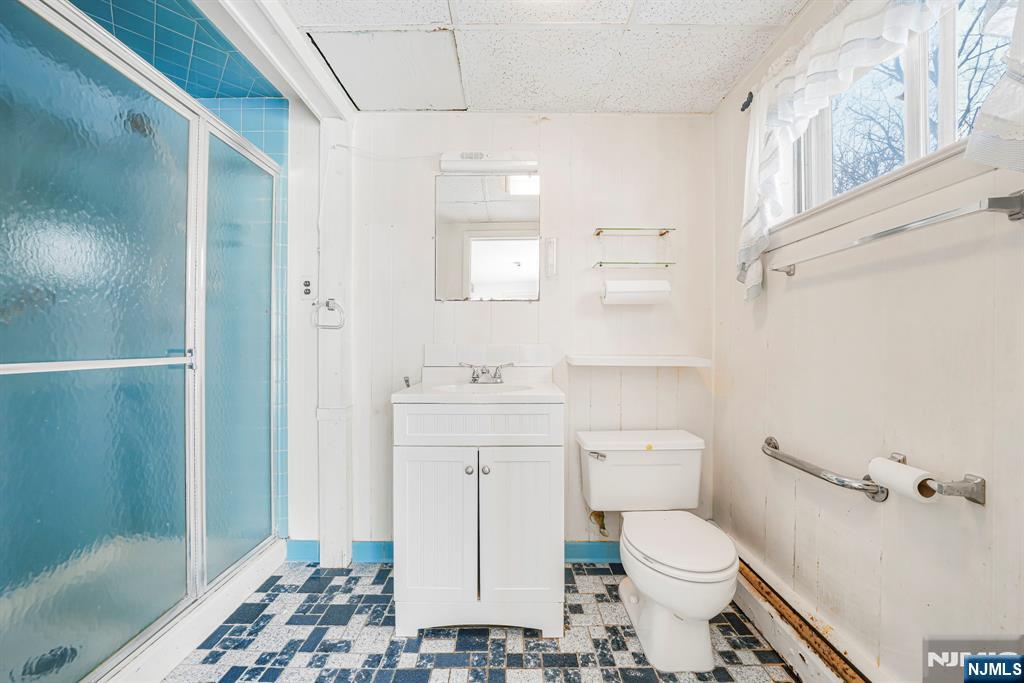 645 Wildwood Road West Northvale, NJ 07647 - Photo 9 of 35 a bathroom with a toilet a sink and shower