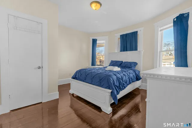 a spacious bedroom with a bed and a window