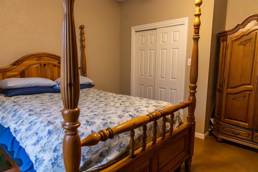 2946 Fm 52 Graford, TX 76449 - Photo 8 of 40 a bedroom with a bed and wooden floor