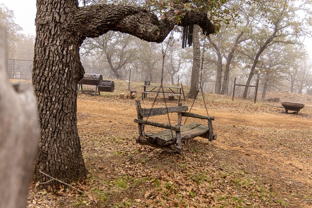 2946 Fm 52 Graford, TX 76449 - Photo 11 of 40 a bench sitting in the middle of a yard
