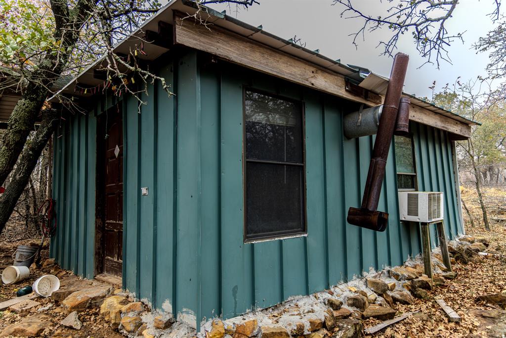 2946 Fm 52 Graford, TX 76449 - Photo 12 of 40 a view of a house with a wooden fence and trees
