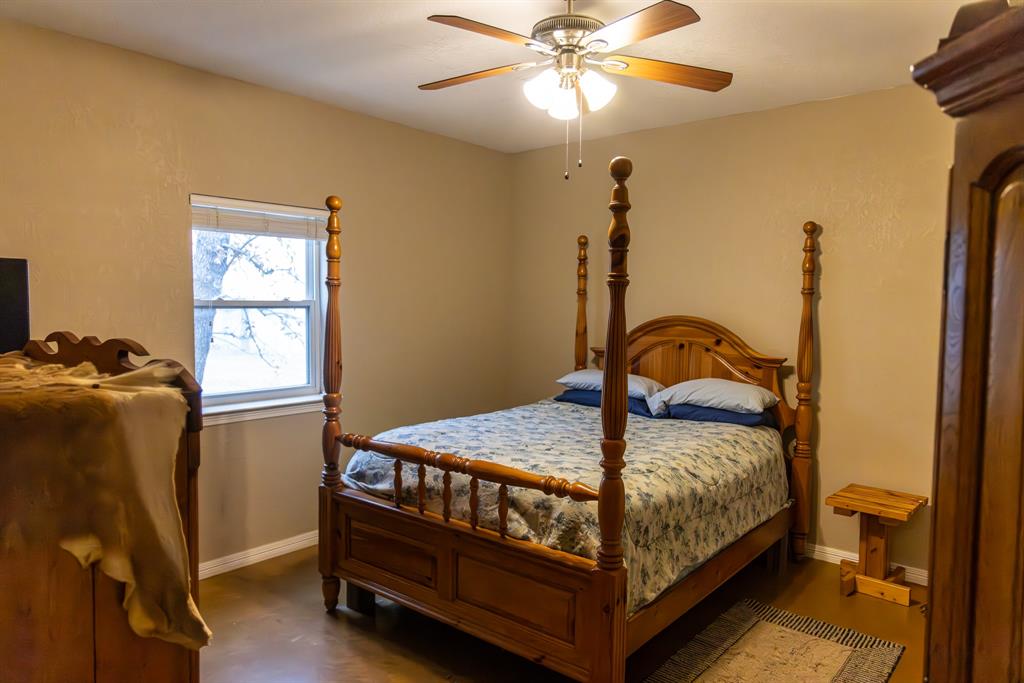 2946 Fm 52 Graford, TX 76449 - Photo 7 of 40 a bed sitting in a bedroom next to a window
