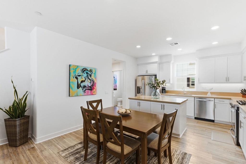 4367 Pacifica Way, Unit 2 Oceanside, CA 92056 - Photo 12 of 37 a view of a dining room with furniture window and wooden floor