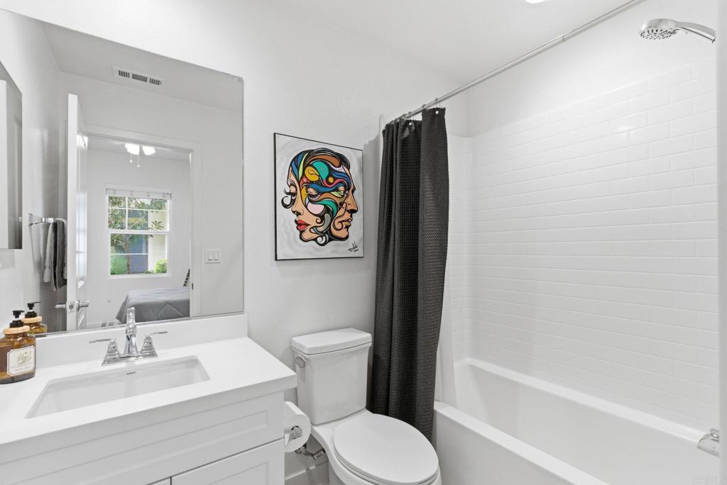 4367 Pacifica Way, Unit 2 Oceanside, CA 92056 - Photo 7 of 37 a bathroom with a sink toilet and vanity