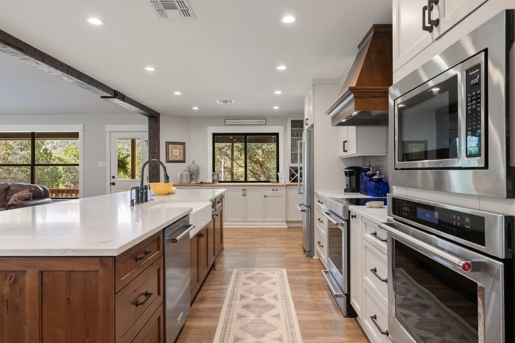23644 Nameless Road Leander, TX 78641 - Photo 8 of 40 An inviting kitchen with a central island and contemporary stainless steel appliances, ideal for culinary creations.