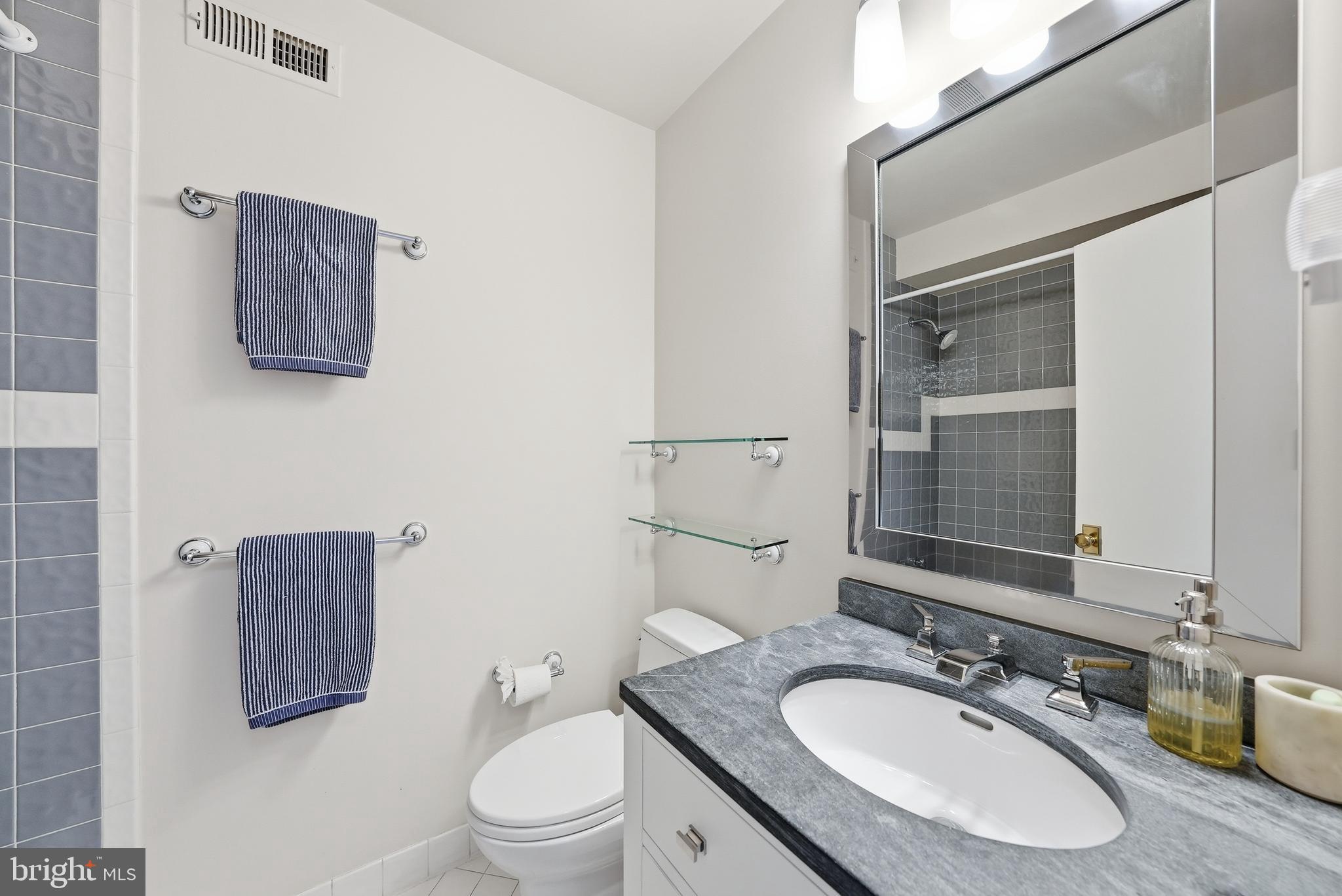 2806 27th Street Northwest Washington, DC 20008 - Photo 22 of 34 a bathroom with a granite countertop toilet sink and mirror