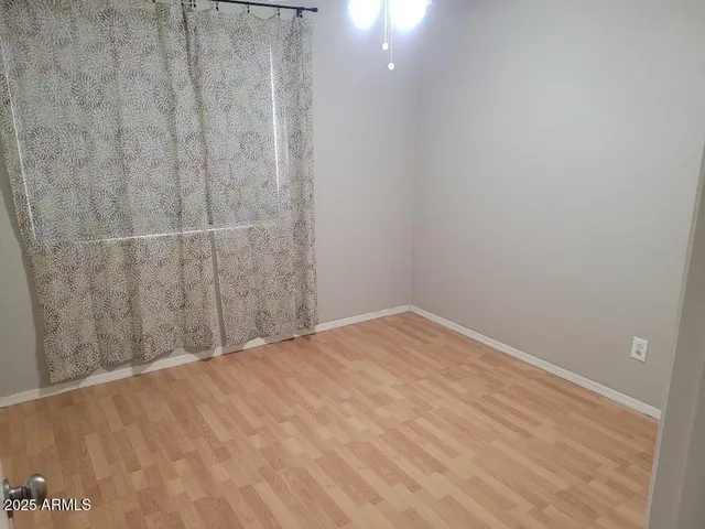a view of a room with wooden floor