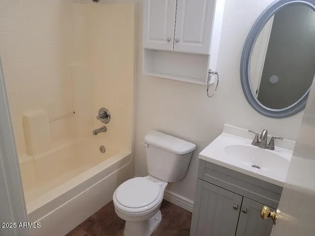 a bathroom with a sink toilet vanity and shower