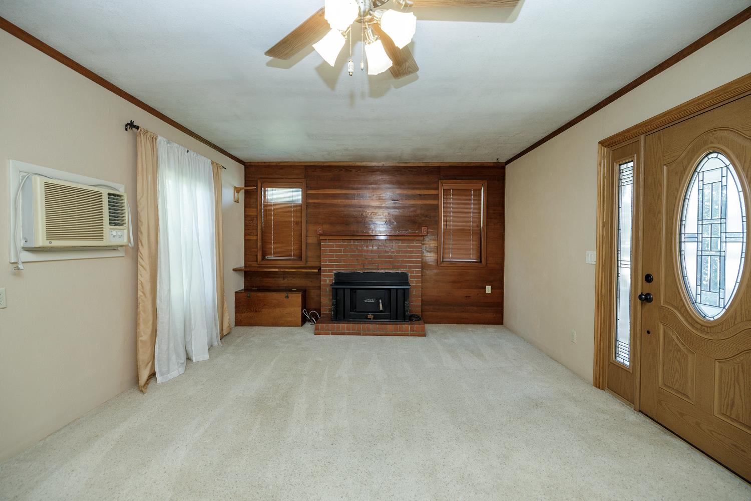 4541 North Gratton Road Denair, CA 95316 - Photo 17 of 75 a view of an empty room with a fireplace and a chandelier