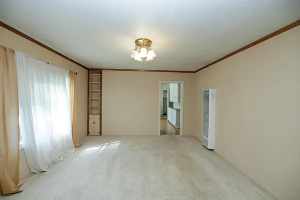 a view of walk in closet with empty racks