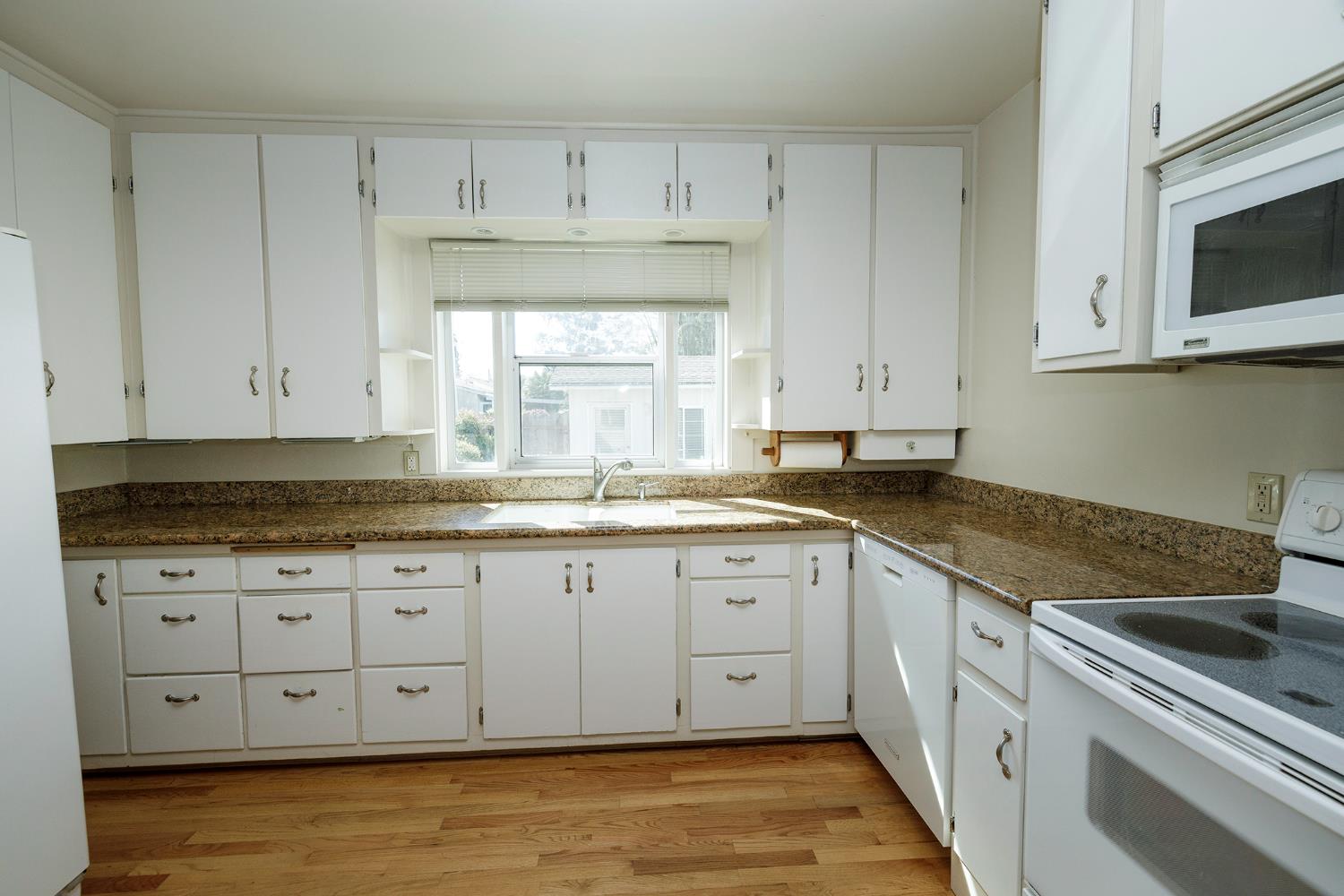 4541 North Gratton Road Denair, CA 95316 - Photo 25 of 75 a kitchen with granite countertop a sink and cabinets