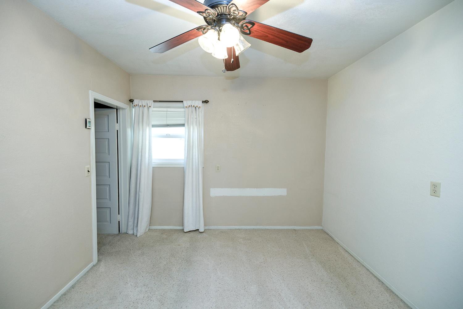 4541 North Gratton Road Denair, CA 95316 - Photo 29 of 75 an empty room with chandelier fan and windows