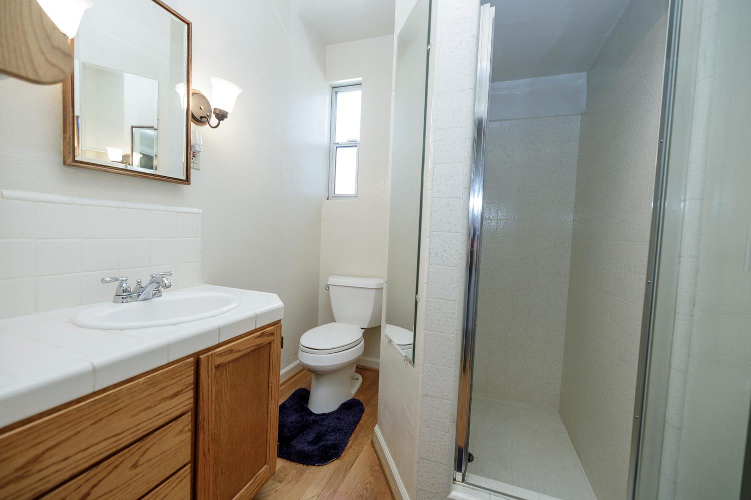4541 North Gratton Road Denair, CA 95316 - Photo 32 of 75 a bathroom with a granite countertop toilet sink and mirror