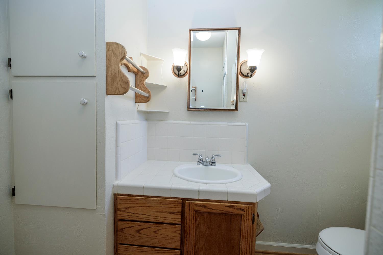 4541 North Gratton Road Denair, CA 95316 - Photo 33 of 75 a bathroom with a sink a toilet and mirror