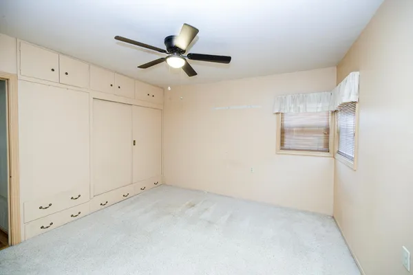 a view of an empty room with a cabinet