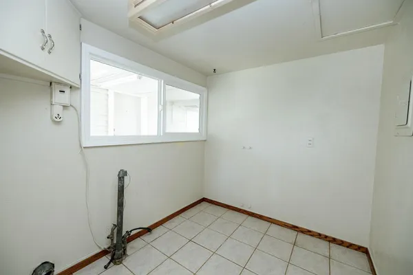a bathroom with a bathtub a window and a shower