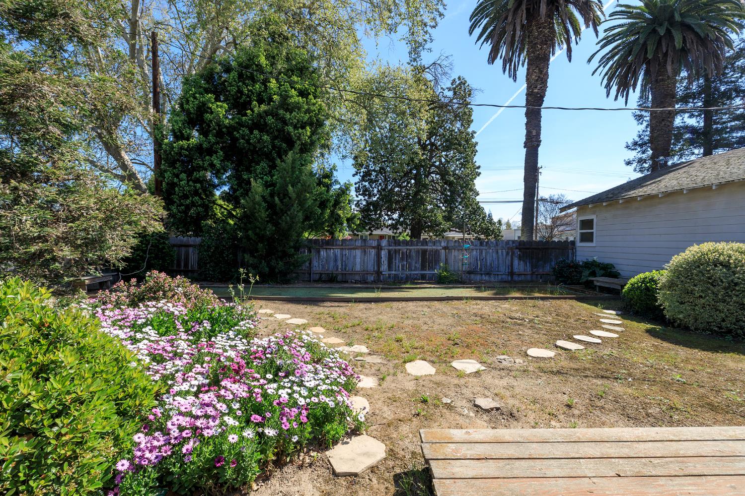 4541 North Gratton Road Denair, CA 95316 - Photo 45 of 75 a view of a backyard with potted plants and large trees