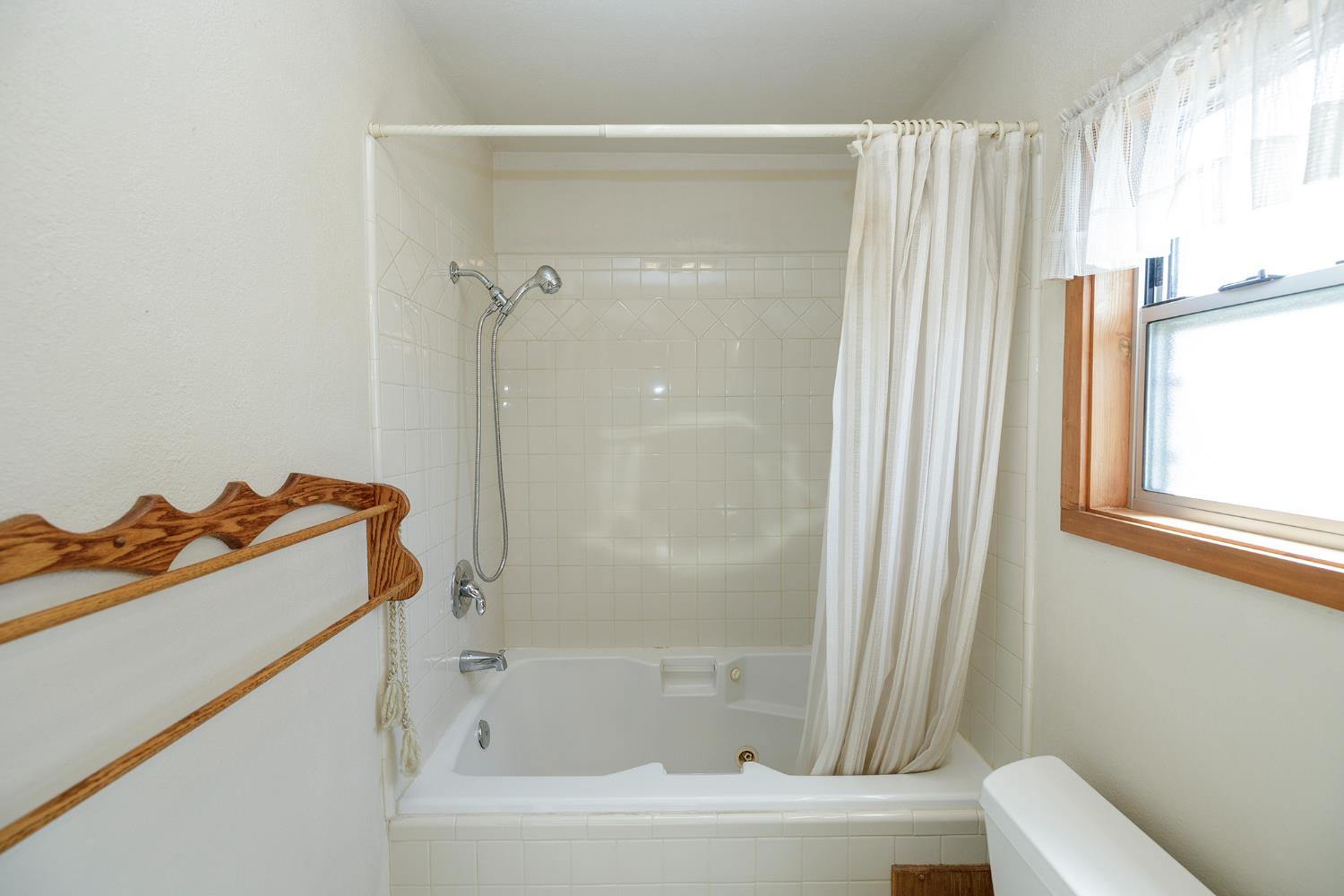 4541 North Gratton Road Denair, CA 95316 - Photo 52 of 75 a bathroom with a bathtub a window and a shower