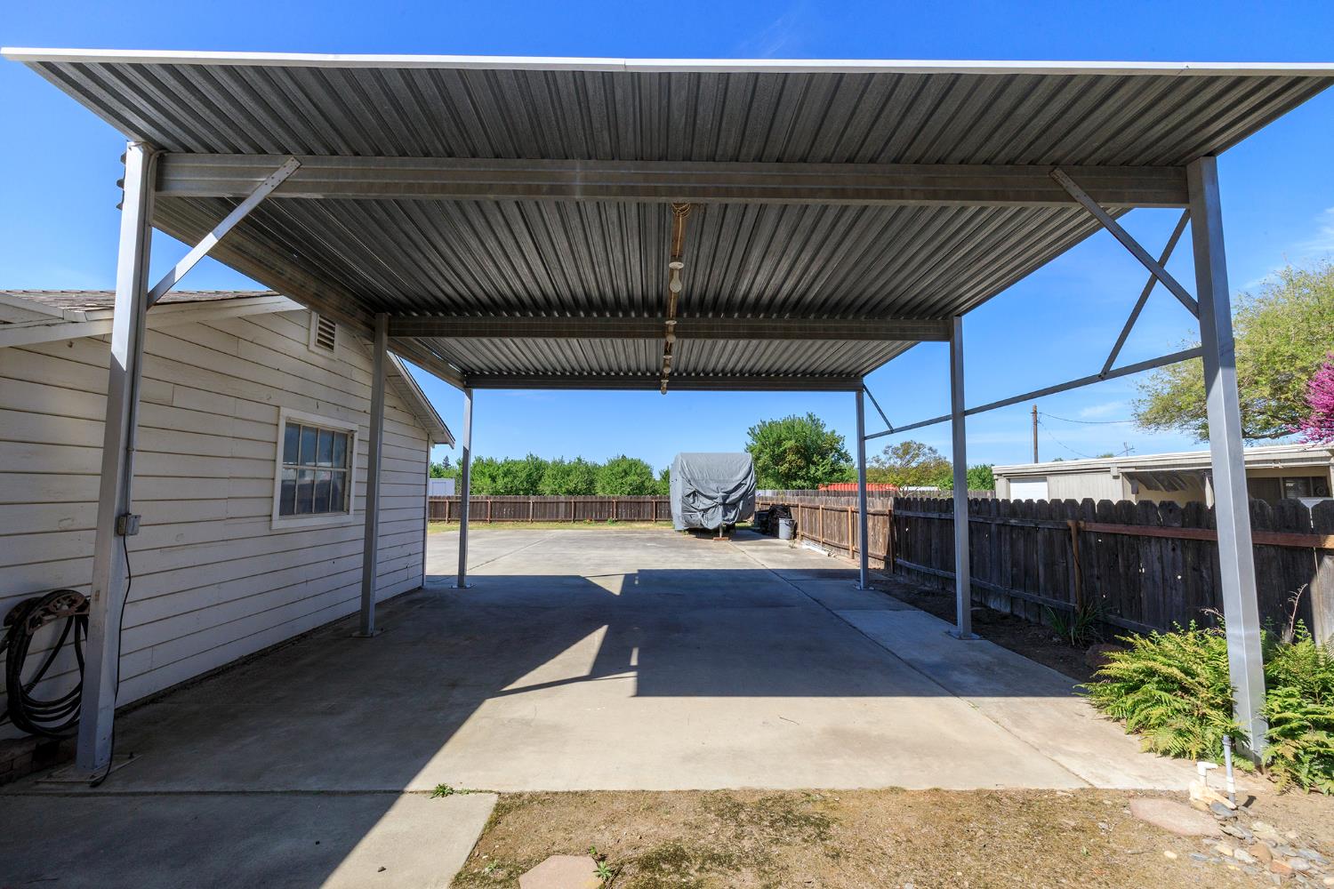 4541 North Gratton Road Denair, CA 95316 - Photo 55 of 75 a view of a patio with table and chairs a barbeque with wooden fence