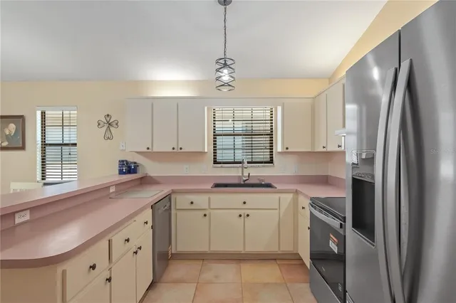 a kitchen with a sink stove and refrigerator