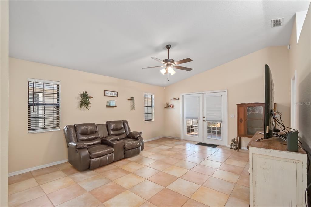 3911 Northeast 22nd Street Ocala, FL 34470 - Photo 15 of 46 a living room with furniture and a flat screen tv