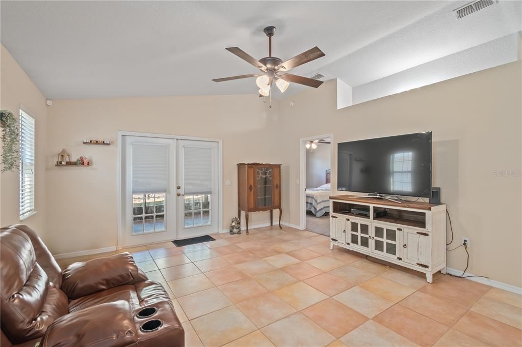 3911 Northeast 22nd Street Ocala, FL 34470 - Photo 16 of 46 a living room with furniture and a flat screen tv