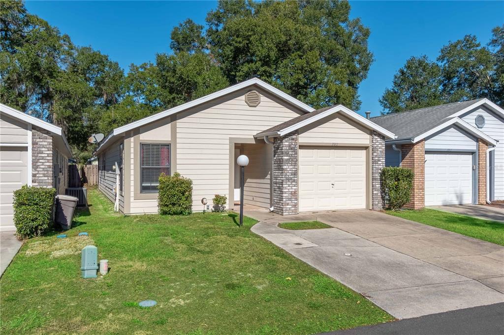 3911 Northeast 22nd Street Ocala, FL 34470 - Photo 2 of 46 a view of a house with a yard and large tree