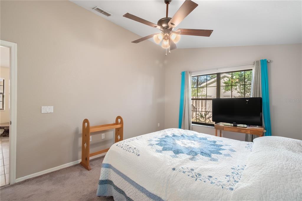 3911 Northeast 22nd Street Ocala, FL 34470 - Photo 22 of 46 a bedroom with a bed and a flat screen tv