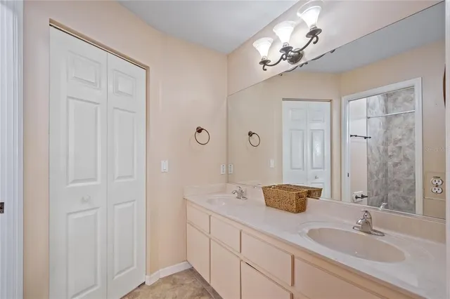 a bathroom with a double vanity sink and a mirror