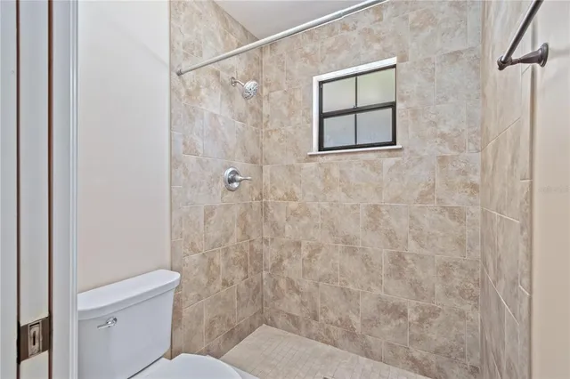 a bathroom with a toilet and a shower