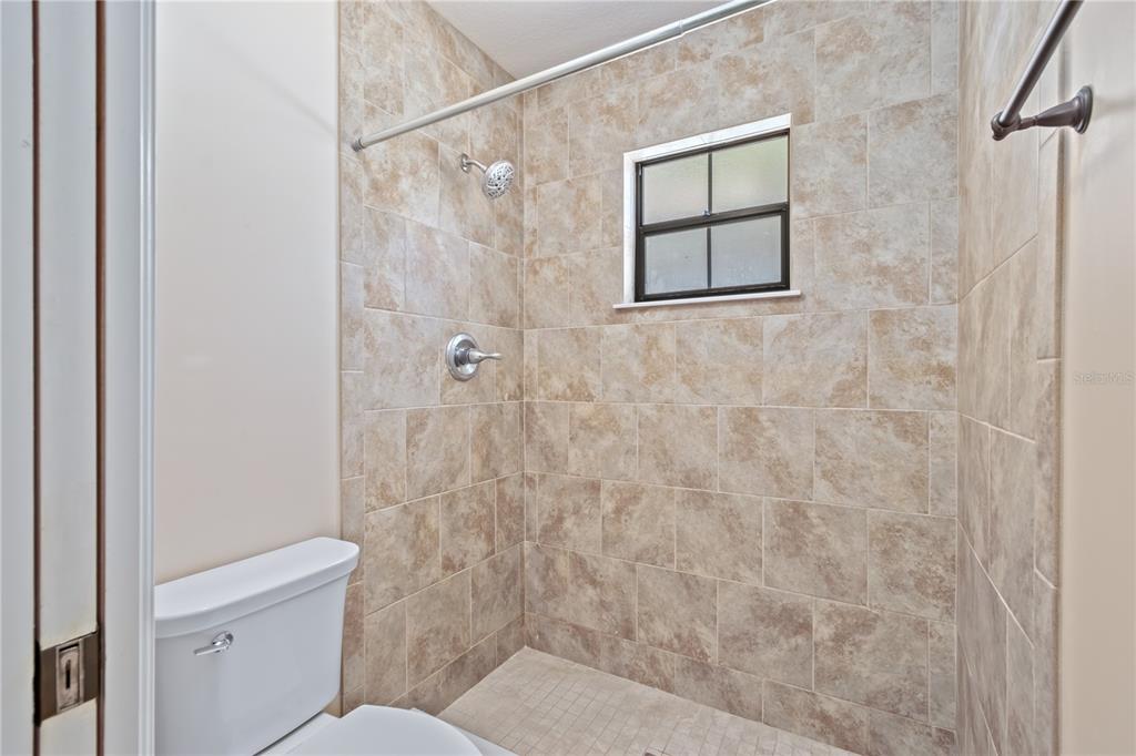 3911 Northeast 22nd Street Ocala, FL 34470 - Photo 24 of 46 a bathroom with a toilet and a shower