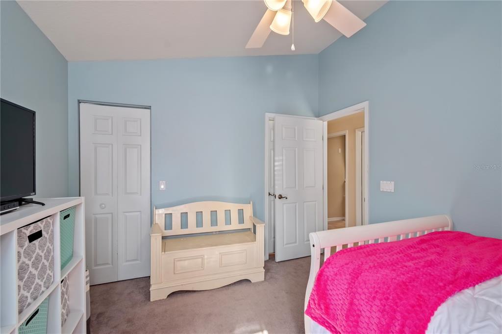 3911 Northeast 22nd Street Ocala, FL 34470 - Photo 28 of 46 a bedroom with a bed and a flat tv screen on dresser