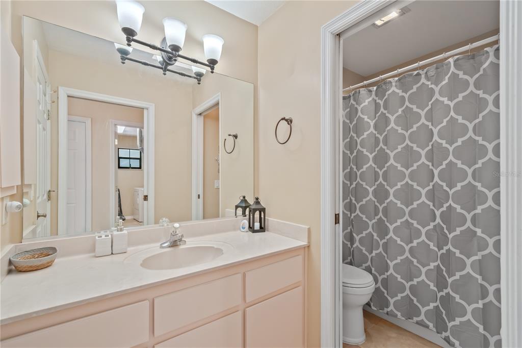 3911 Northeast 22nd Street Ocala, FL 34470 - Photo 30 of 46 a bathroom with a double vanity sink a mirror and a shower