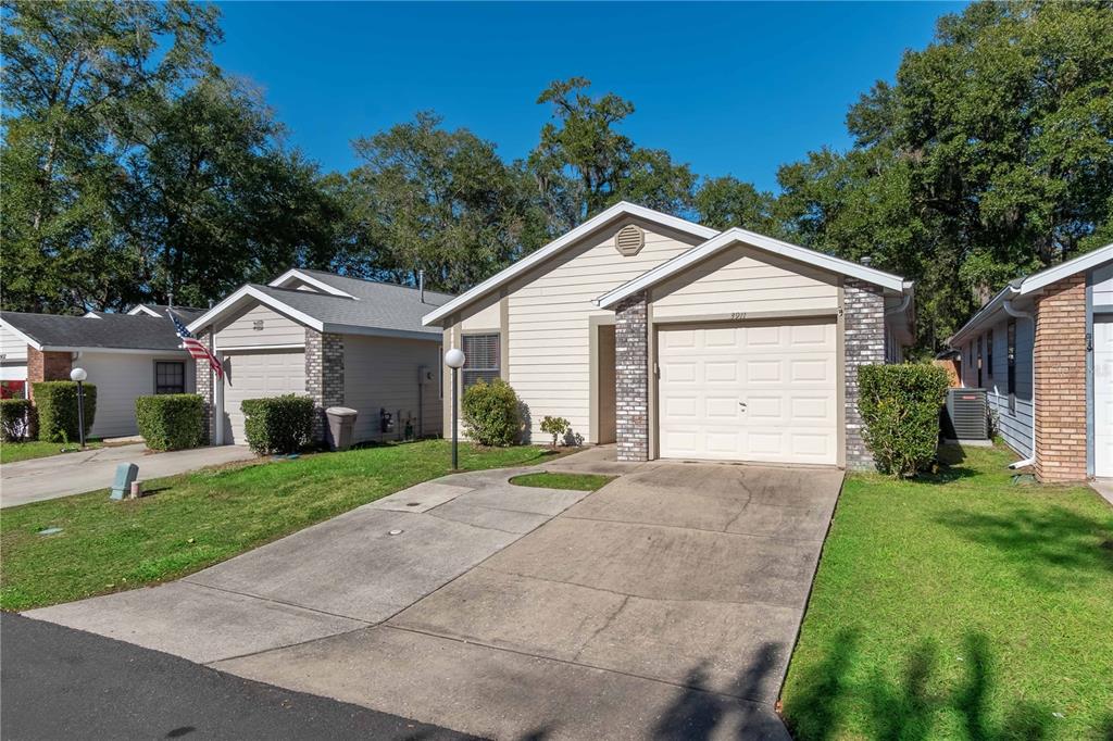 3911 Northeast 22nd Street Ocala, FL 34470 - Photo 3 of 46 a front view of a house with a yard and garage
