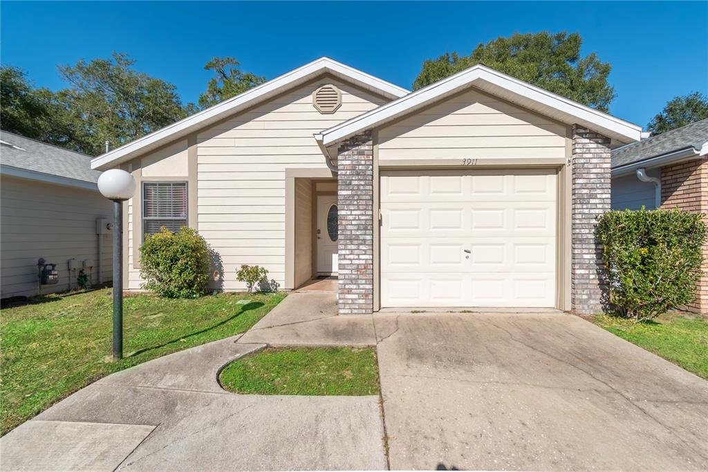 3911 Northeast 22nd Street Ocala, FL 34470 - Photo 5 of 46 a front view of a house with a garden
