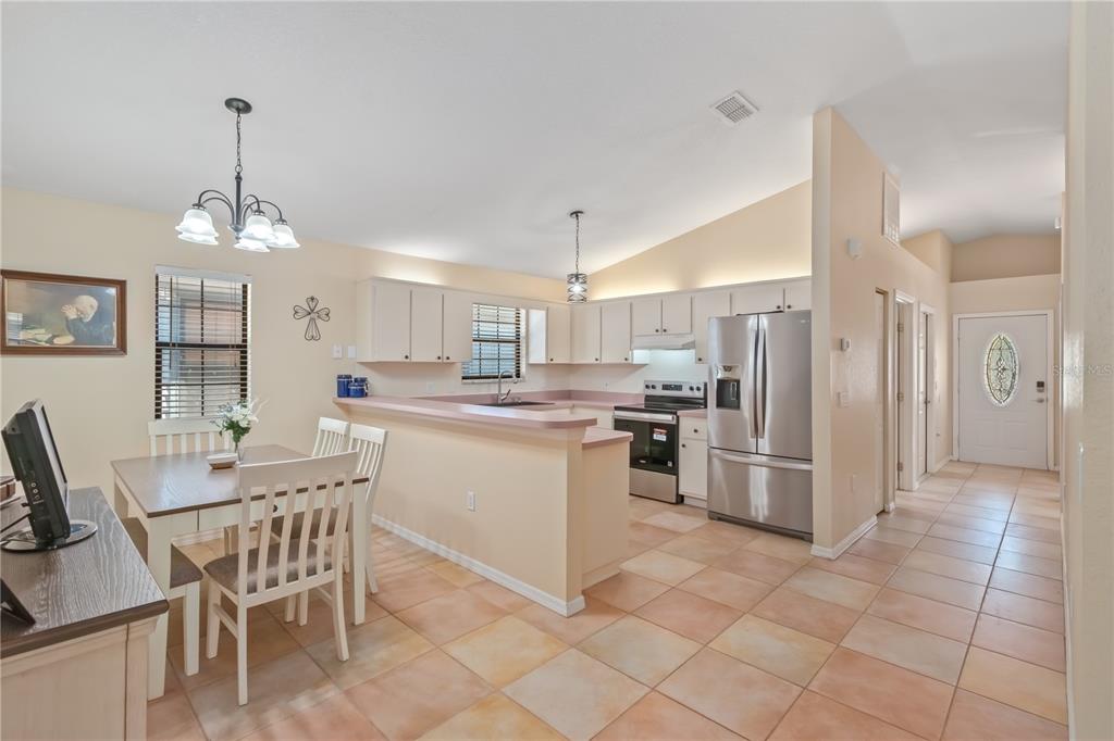 3911 Northeast 22nd Street Ocala, FL 34470 - Photo 9 of 46 a kitchen with refrigerator and cabinets