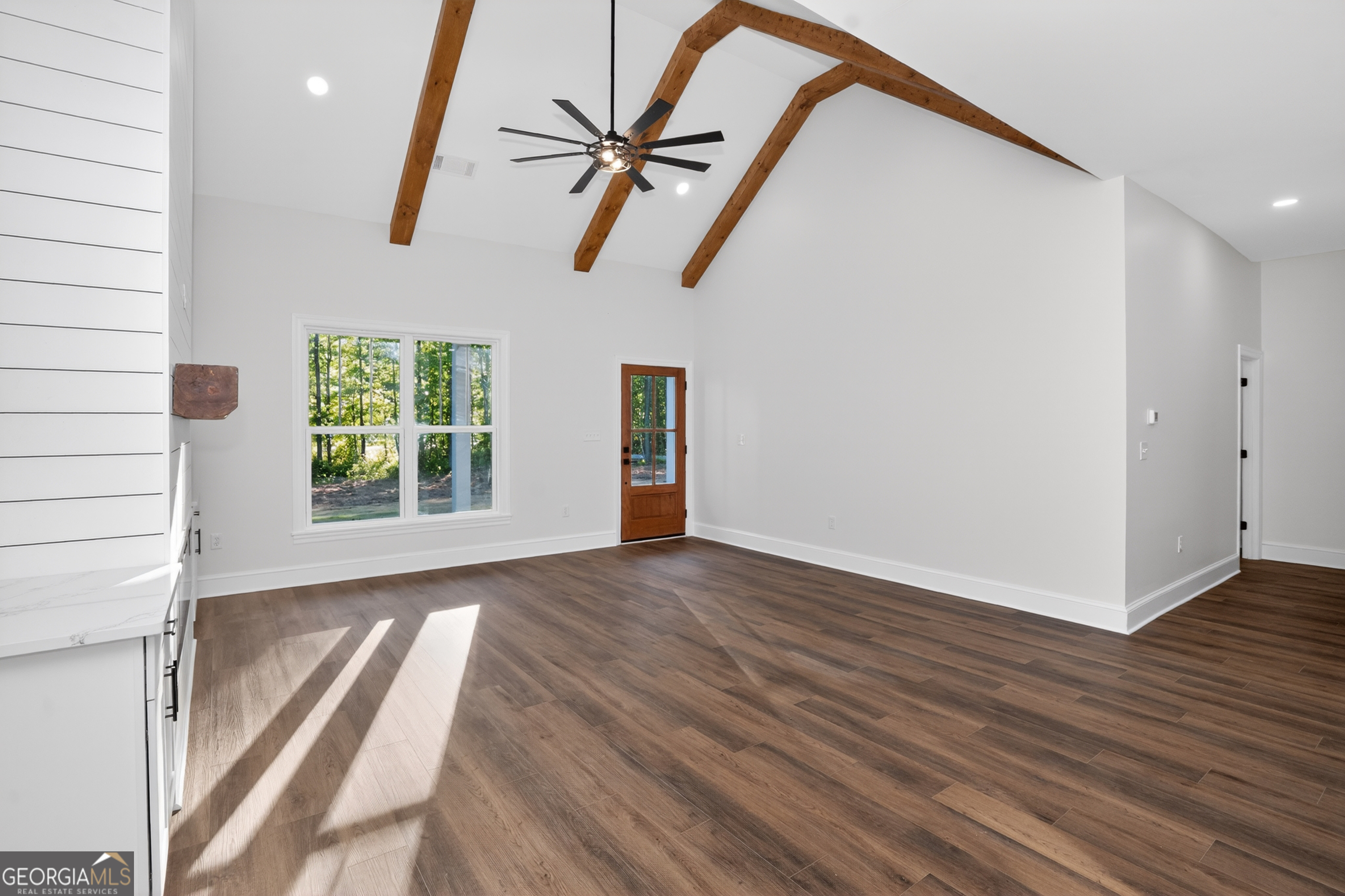 166 Midway Road Barnesville, GA 30204 - Photo 11 of 62 an empty room with wooden floor fan and windows