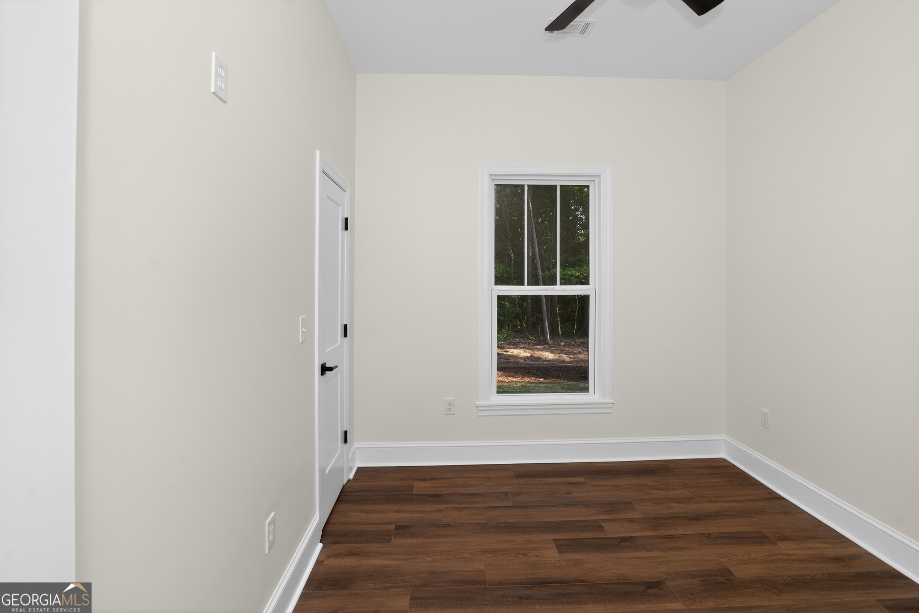 166 Midway Road Barnesville, GA 30204 - Photo 23 of 62 a view of an empty room with wooden floor and a window