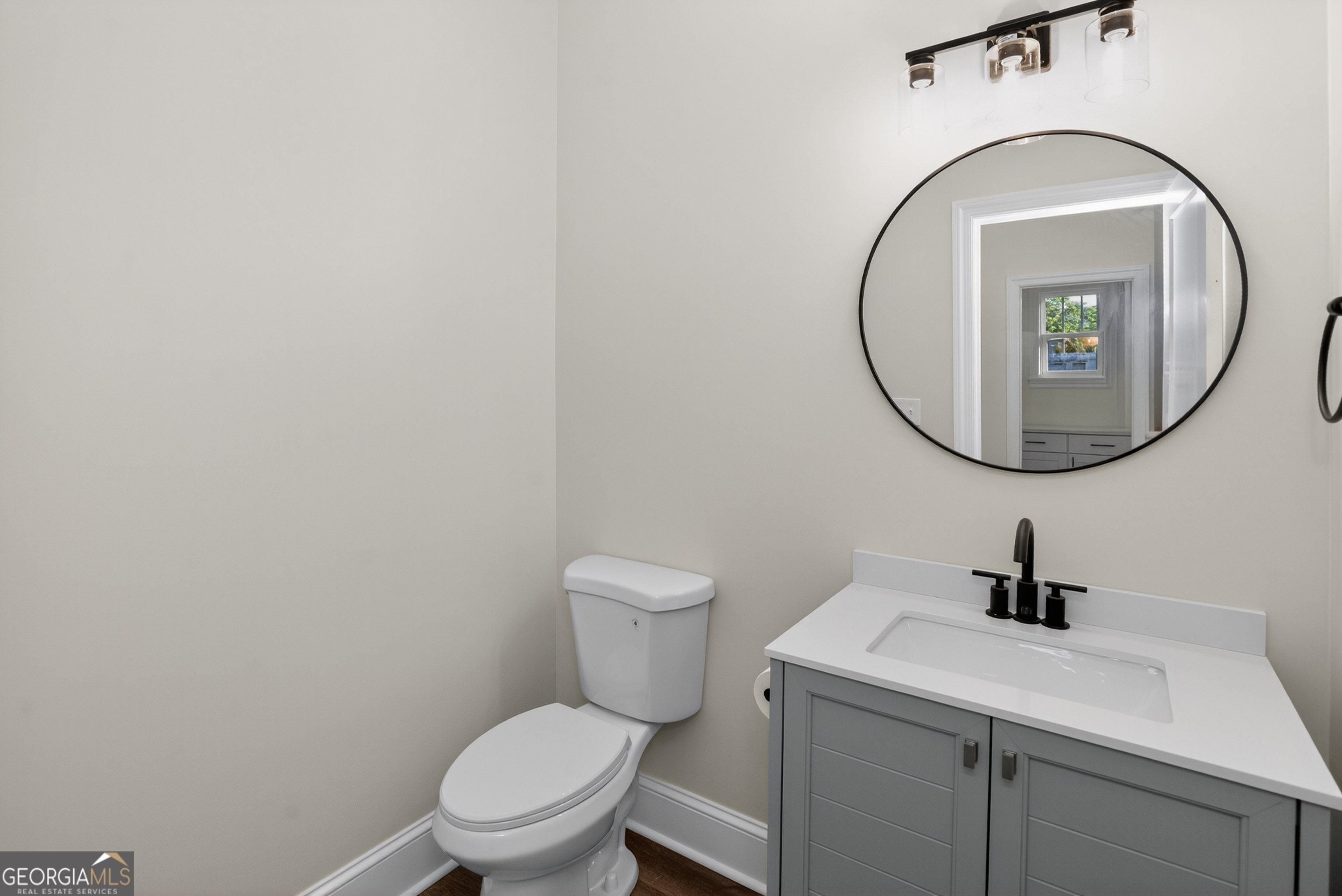 166 Midway Road Barnesville, GA 30204 - Photo 29 of 62 a bathroom with a toilet a sink and mirror
