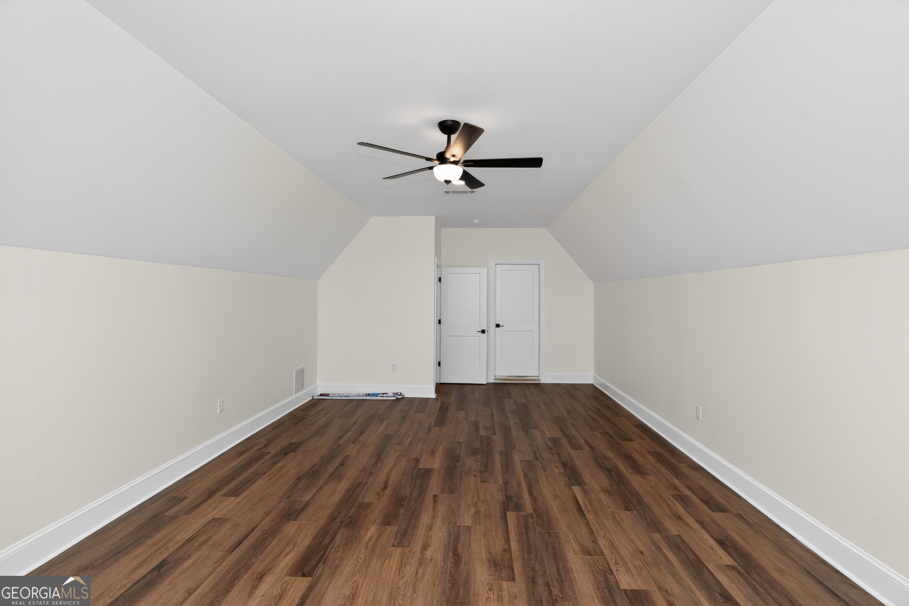 166 Midway Road Barnesville, GA 30204 - Photo 48 of 62 a view of a room with wooden floor and a ceiling fan