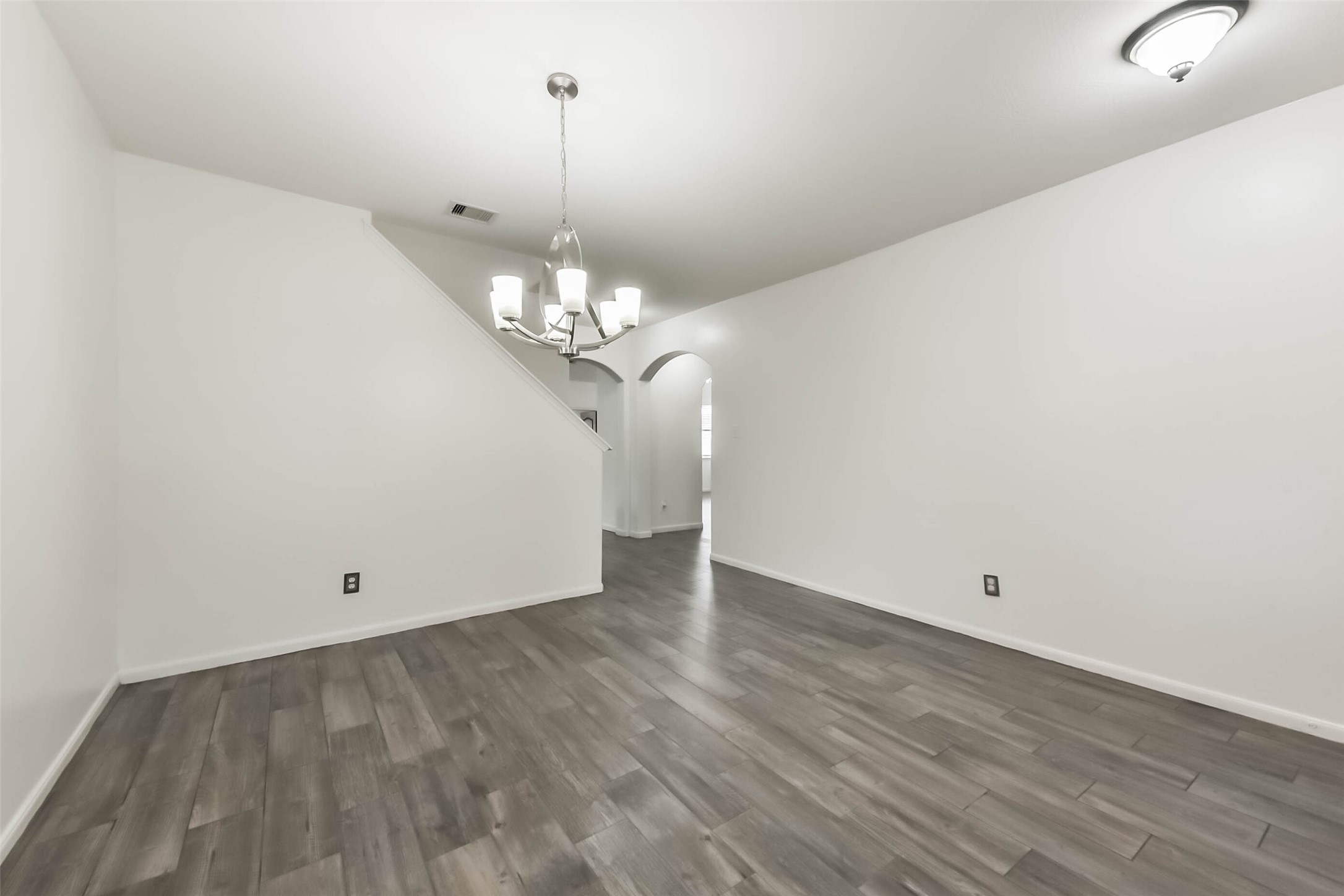 10114 Sand Tracks Court Houston, TX 77064 - Photo 17 of 49 a view of a chandelier in big room with wooden floor